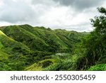 Beautiful green hills during a road trip in Guam with dramatic skies