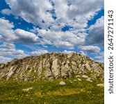 beautiful green mountain backbone under blue cloudy sky