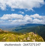 beautiful green mountain backbone under blue cloudy sky