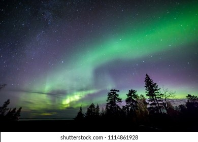 A Beautiful Green And Red Aurora Dancing