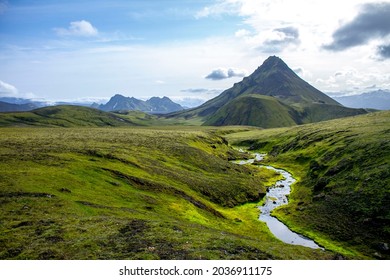 Beautiful green valley with mountains and river while trekking in Iceland