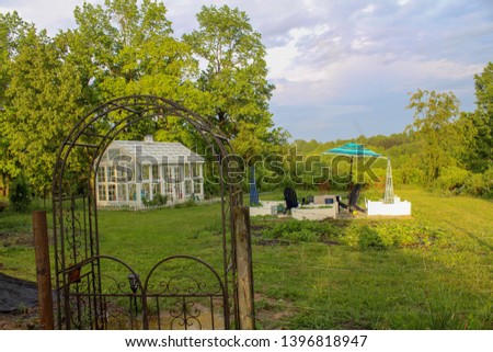 Beautiful Greenhouse and Garden on Spring Day