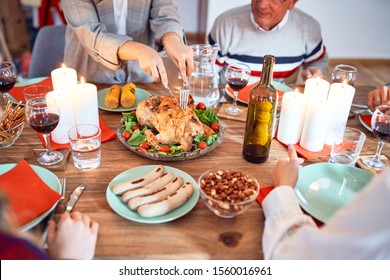 Beautiful group of people meeting smiling happy and confident. Carving roasted turkey celebrating Thanksgiving Day at home - Shutterstock ID 1560016961