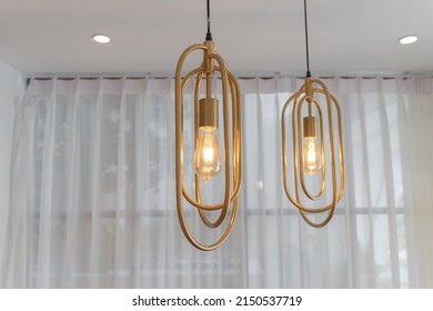 Beautiful group set of modern ceiling lamp lights bulbs it has a vertical gold metal frame decoration for home and living with space for copy text. Contemporary office building concept.