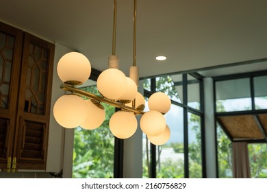 Beautiful group set of modern ceiling lamp lights bulbs ball shape it has a gold metal frame decoration for home and living with space for copy text. Contemporary interior for office building concept.