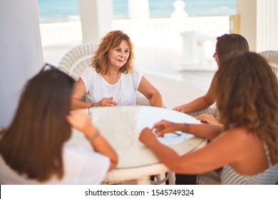 Beautiful group of women sitting at terrace speaking and smiling - Shutterstock ID 1545749324