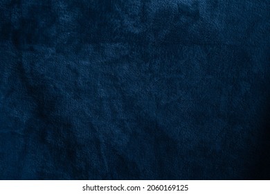 Beautiful grunge velvet dark navy blue background. Wide banner or wallpaper rough styled with space for text and design. Uneven velvety photography backdrop
