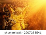 Beautiful guardian angel against blur background Ancient stone statue. Copy space.