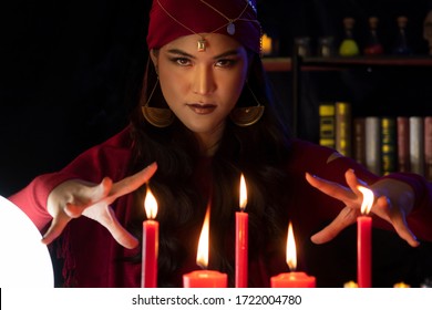 Beautiful Gypsy fortune teller woman casting a magical spell over candle while predicting the future. Divine magic, Forecast esoteric astrology superstition, magical power, alchemy, Black magic. - Shutterstock ID 1722004780