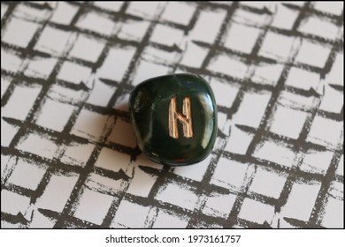 Beautiful Hagalaz Rune made of Bloodstone with interesting background
