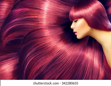 Beautiful Hair. Beauty woman with luxurious long red hair as background. Beauty Model girl with Healthy Hair. Beautiful woman with long smooth shiny straight hair. Hairstyle. Hair cosmetics, haircare