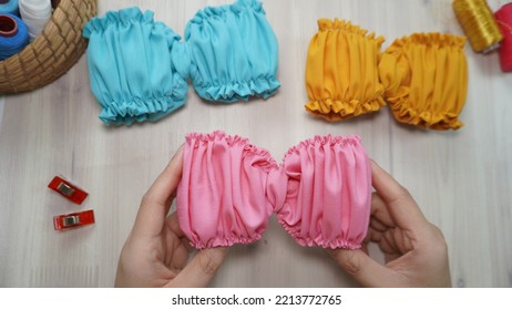 Beautiful Hair Bow With Ruffle Design In Beautiful Soft Color Made Out Of Cotton Fabric On Wooden Table