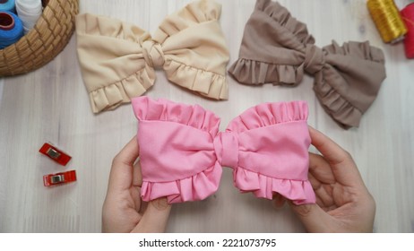 Beautiful Hair Bow With Ruffle Design In Beautiful Pastel Colors Made Out Of Cotton Fabric On Wooden Table