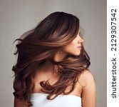 Beautiful Hair swinging head from side to side, Young beautiful woman with long perfect healthy lovely shiny hair, happy with beauty products, hair shampoo or conditioner