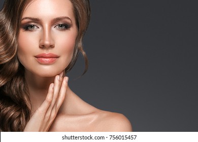 Beautiful hair woman beauty skin portrait over dark background. Long beautiful healthy hair model girl stock image. Studio shot.
