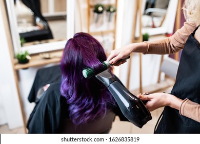 Beautiful hairstyle of young adult woman with purple hair in hair salon. - Powered by Shutterstock