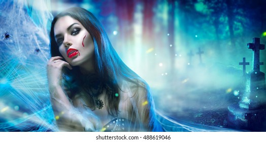 Beautiful Halloween Vampire Woman portrait. Beauty Sexy Vampire Witch lady with blood on mouth posing in cemetery, wearing spider web. Fashion Art design. Mysterious Model girl with Halloween make up