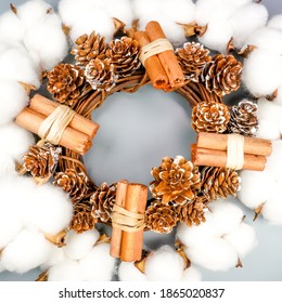 Beautiful hand made Christmas wooden wreath decorated with a bow, cinnamon and pine cones on gray background. - Powered by Shutterstock