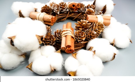 Beautiful hand made Christmas wooden wreath decorated with a bow, cinnamon and pine cones on gray background. - Powered by Shutterstock