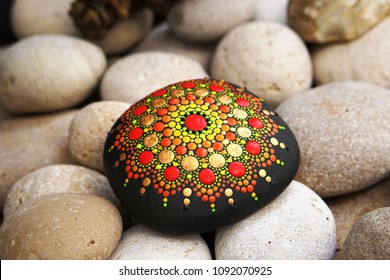 Beautiful Hand Painted Mandala Stone Lies On The Rocks