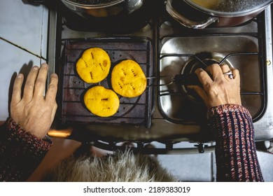 Beautiful Hands Of Elderly Latino Woman Cooking On Traditional Kitchen Stove With Gas Burners With Traditional Toaster With 'sopaipillas' (fried Pastry) And Pots (view From Above)