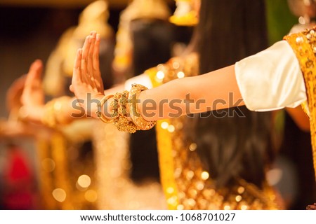 Beautiful hands of Khmer Apsara dance depicting the Ramayana epic, bright golden glittering in the backgrounds, the show is open to the public in Phnom Penh City, Cambodia.