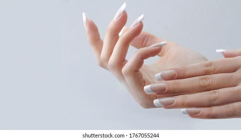 beautiful hands with manicured french nails manicure. nail extension - Shutterstock ID 1767055244