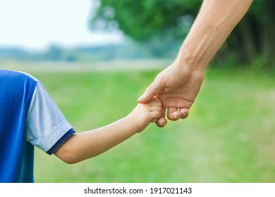 Beautiful Hands Of Parent And Child Outdoors In The Park