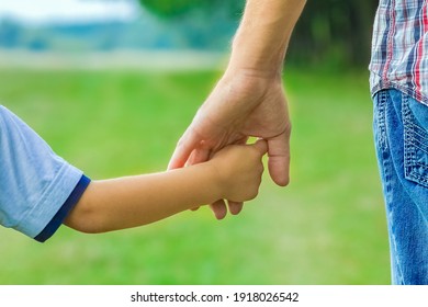 Beautiful Hands Of Parent And Child Outdoors In The Park