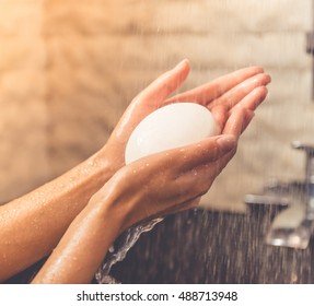 Beautiful Hands Of Young Woman Holding A Soap While Taking Shower In Bathroom