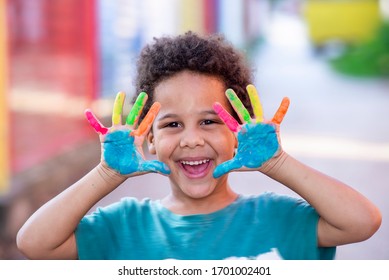 beautiful happy boy with painted hands - Shutterstock ID 1701002401