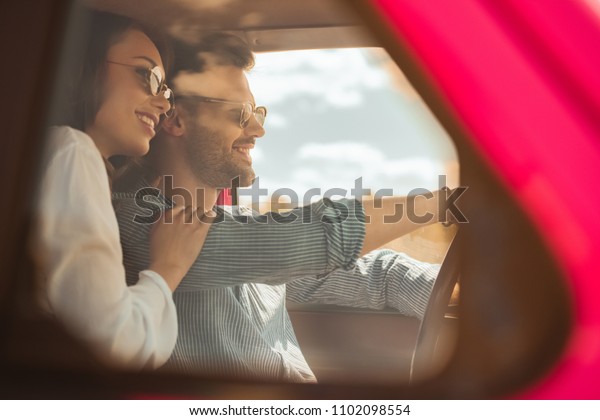 beautiful happy couple\
driving car together
