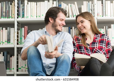 Beautiful happy couple laughing while reading books together at the library copyspace romance education knowledge happiness dating boyfriend girlfriend friends university high school college people - Shutterstock ID 631584908