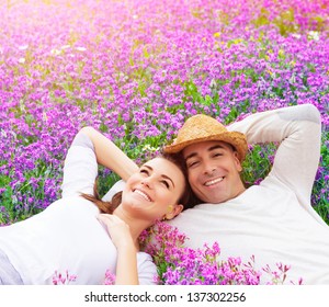 Beautiful happy couple lying down on purple lavender field, having fun on floral glade, summer nature, love concept - Powered by Shutterstock