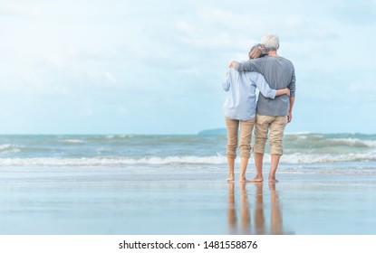 Beautiful happy elderly couple rest at tropical resort,back view