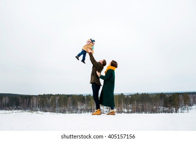 The Beautiful And Happy Family Walks In The Winter Outdoors