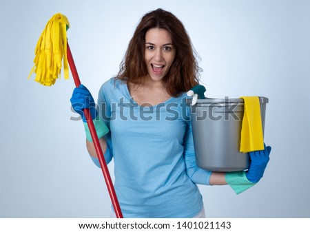 Beautiful happy housewife woman holding cleaning equipment. Proud women, Cleaning service Professional, housemaid and housework. Studio portrait isolated on blue background with copy space.