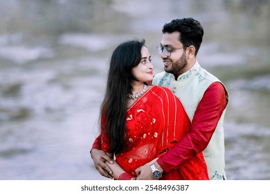 A beautiful, happy Indian bride and groom at a lake – pre-wedding shoot.A beautiful, happy couple at a lake. - Powered by Shutterstock