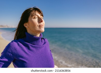 Beautiful Happy Mature Woman Enjoying A Sunny Winter Day At The Beach