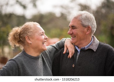 Beautiful And Happy Older Couple, Smiling Outdoors On A Mediterranean Winter Day.