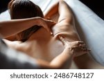 Beautiful happy relaxed woman enjoying professional wellness massage in spa salon