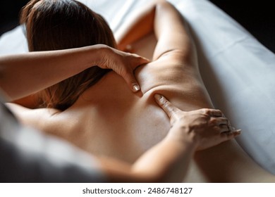 Beautiful happy relaxed woman enjoying professional wellness massage in spa salon - Powered by Shutterstock