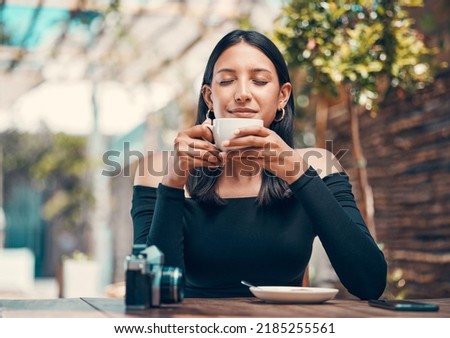 Beautiful, happy and relaxed woman smelling fresh coffee and enjoying a morning in cafe. Calm, zen and content student drinking a warm, hot and comforting cup of beverage drink in relaxing