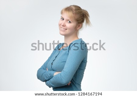 Beautiful happy smiling teen girl in blue sweater over white background