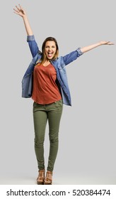 Beautiful Happy Woman With Arms Up Over A Gray Background