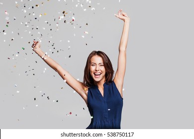 Beautiful happy woman at celebration party with confetti falling everywhere on her. Birthday or New Year eve celebrating concept - Shutterstock ID 538750117