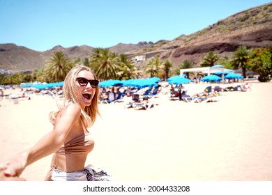 Beautiful Happy Woman Enjoying Sunny Vacation Day On The Beach. Island Summer Vibes. Smiling Girl Having Fun.