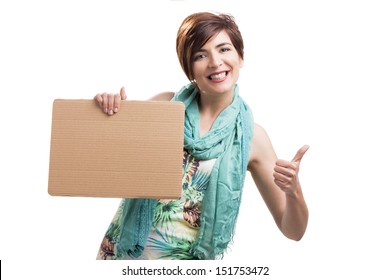 Beautiful and happy woman holding a cardboard and with thumbs up, isolated over a white background