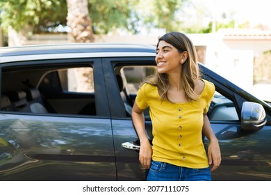 Beautiful Happy Woman Leaning On Her New Car And Laughing During A Beautiful Day Outside