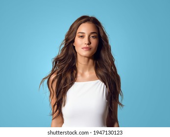 Beautiful Happy Woman With Long Hair In White Dress Over Color Blue Background.Young Happy Model Studio Portrait Beauty Skin And Hairstyle